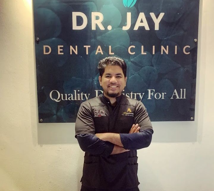 Dr. Sanjay Navajo (Dr. Jay) at the Dr. Jay Dental Clinic signage